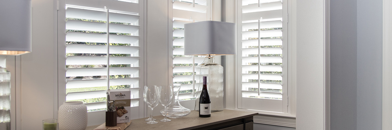 White Polywood shutters in a dining room corner