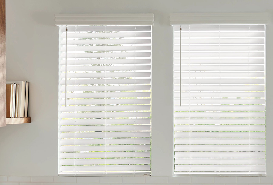 Faux wood basement window blinds next to a bookshelf