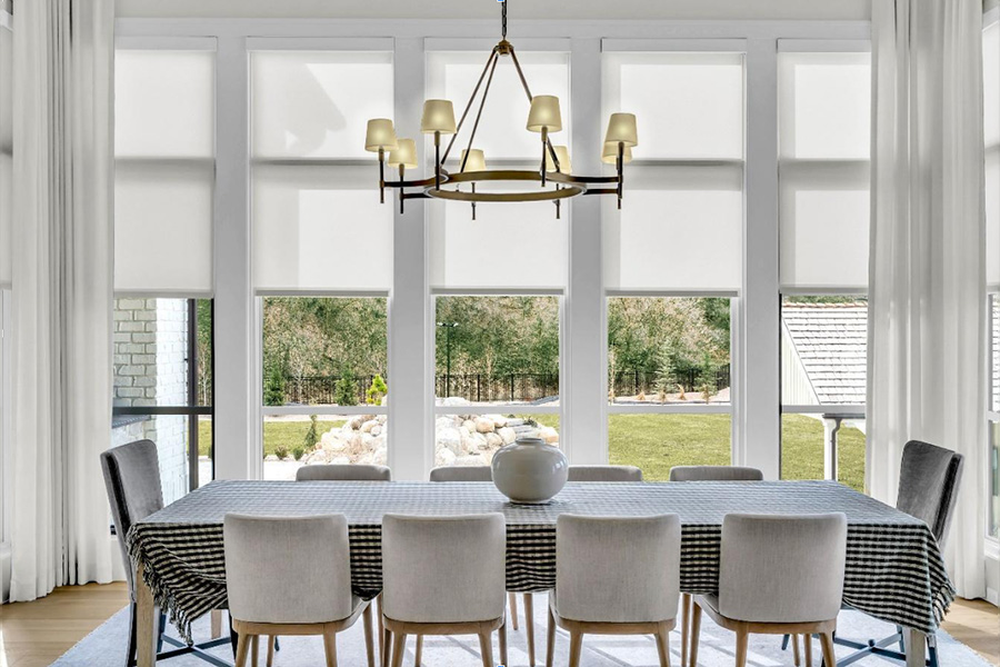 white colored roller shades in living room windows