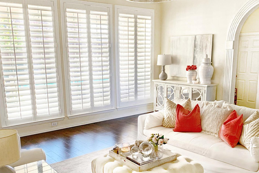 Long white Polywood shutters are easy to clean and maintain all year round. Photo Credit: @ Nifty.nest Long white polywood shutters in a beige and off-white styled living room.